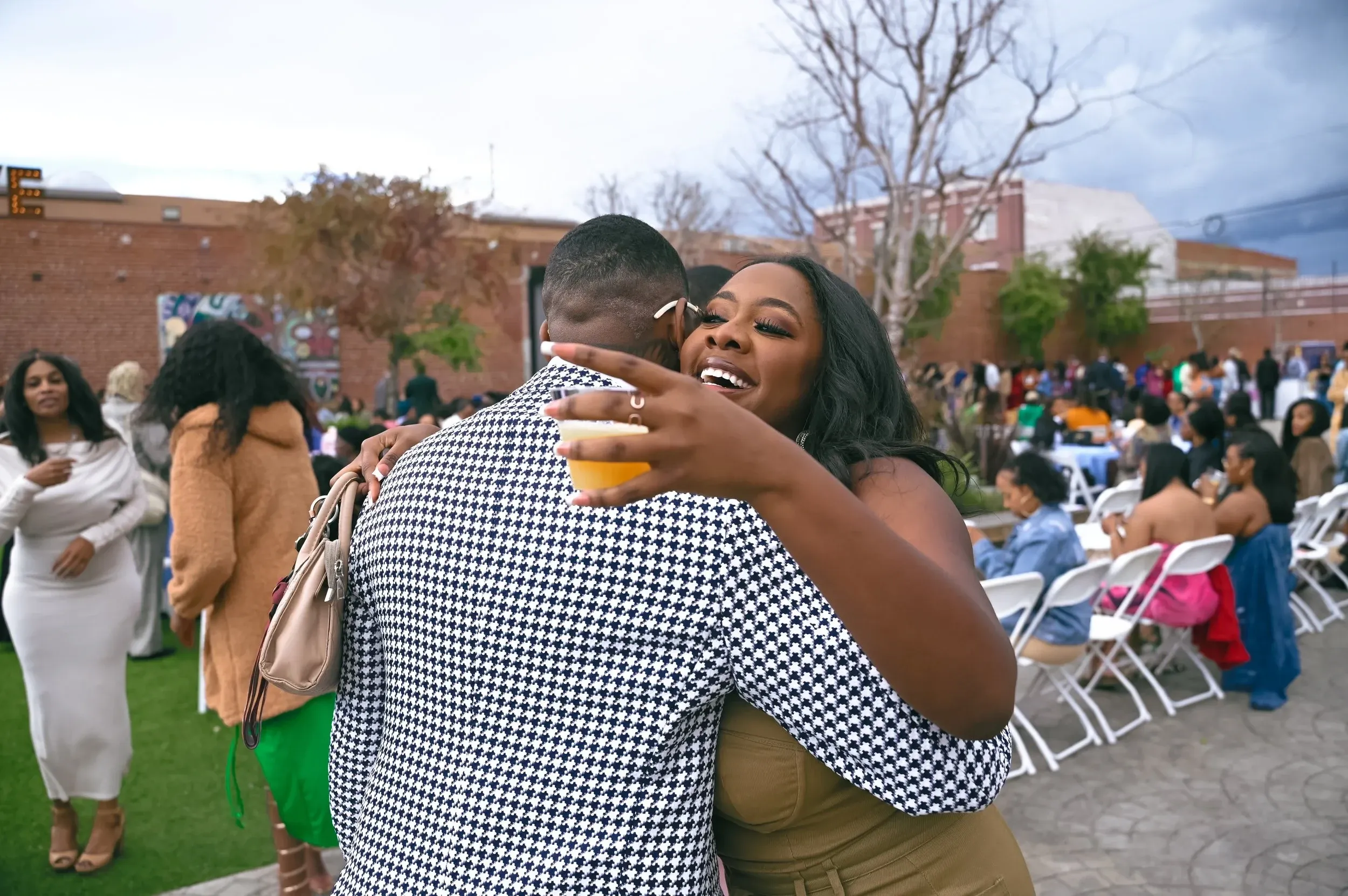 A man embraces a guest at the Black Women’s Appreciation Brunch in Los Angeles
