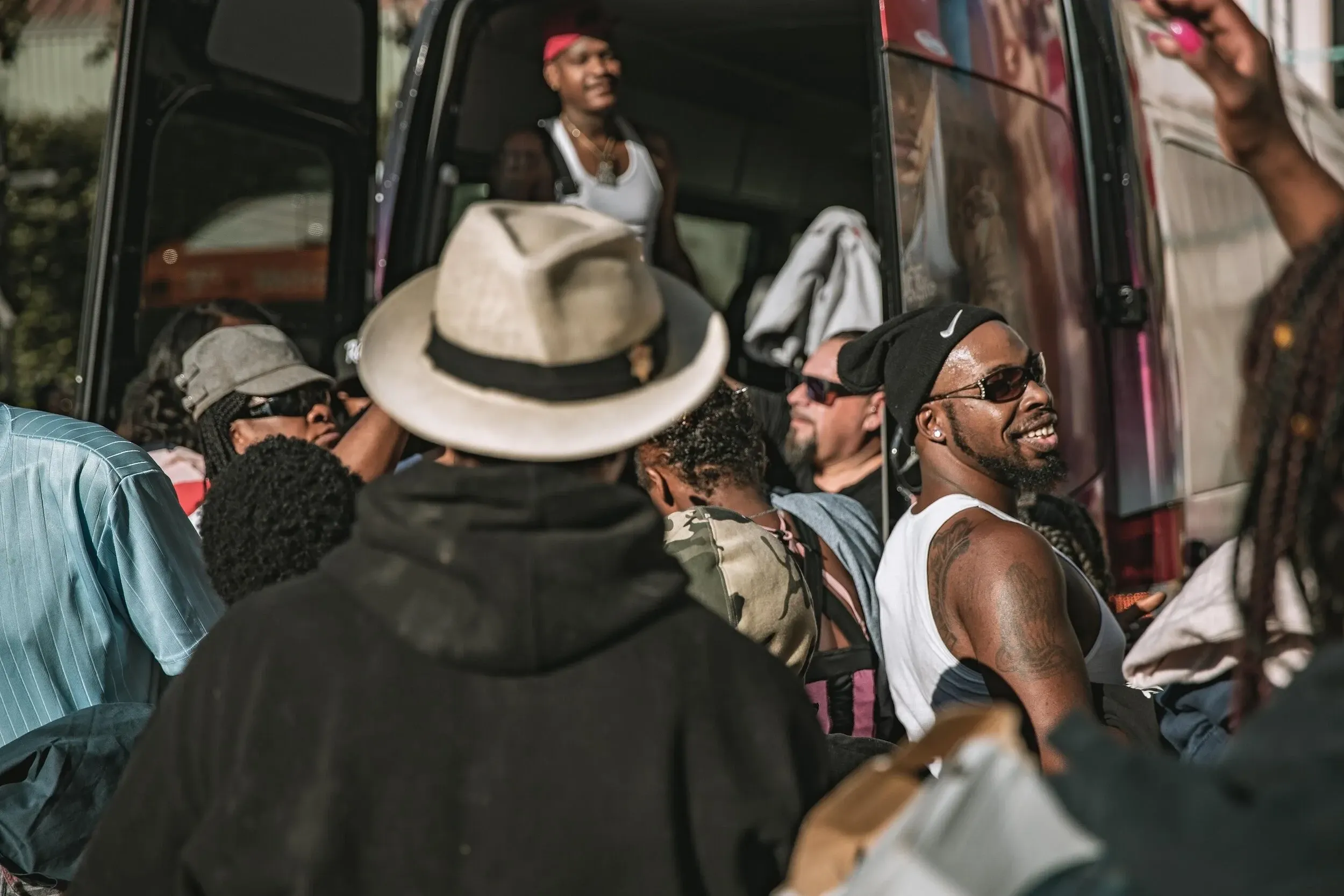 Men gathered around a community member at a Healing Circle LA event in Los Angeles