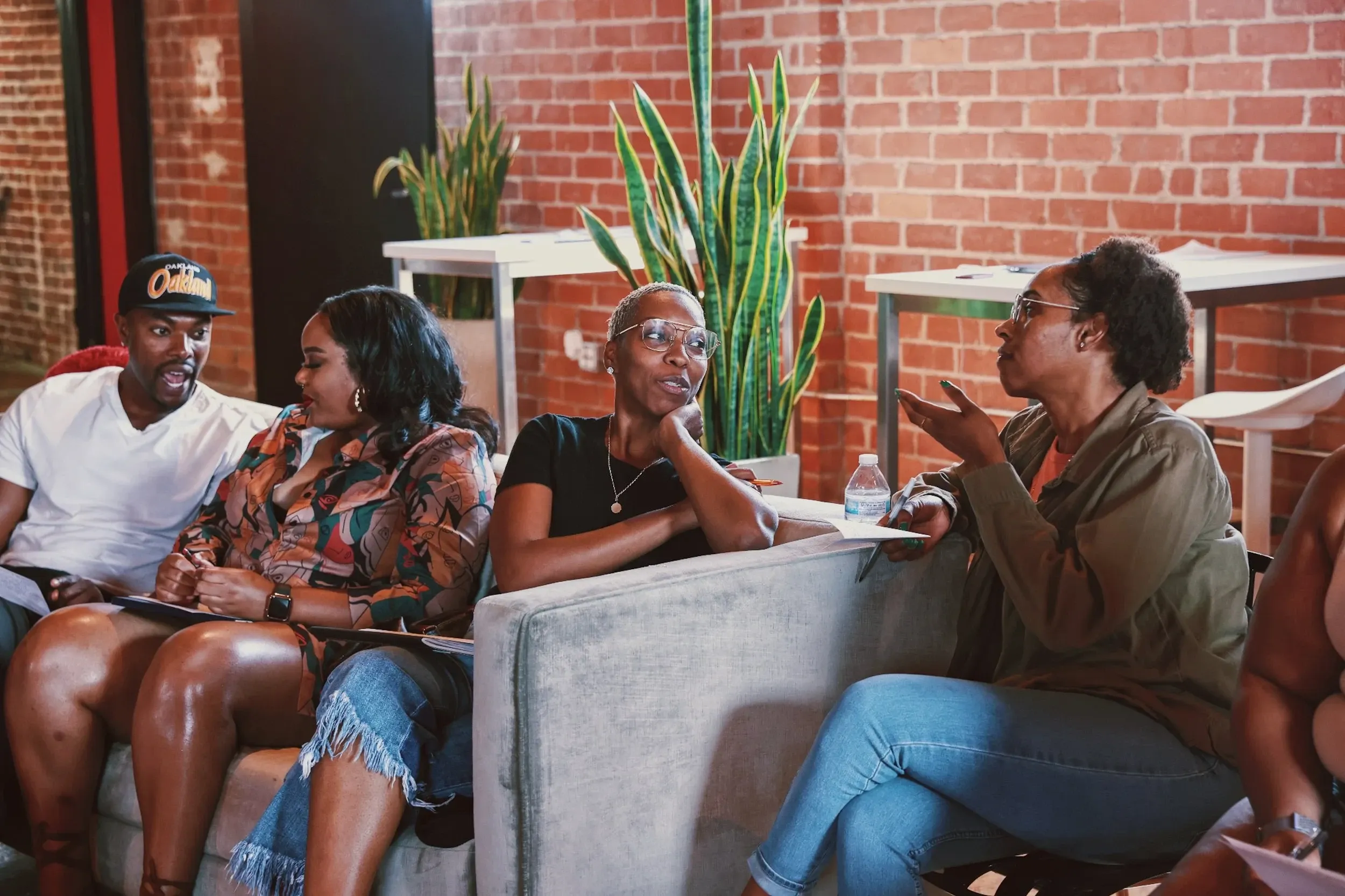 Community members relaxing and talking together on a patio during a Healing Circle LA gathering